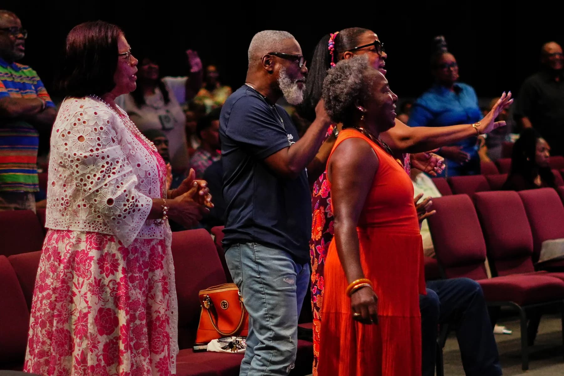 Members of the congregation standing and worshipping together in the sanctuary